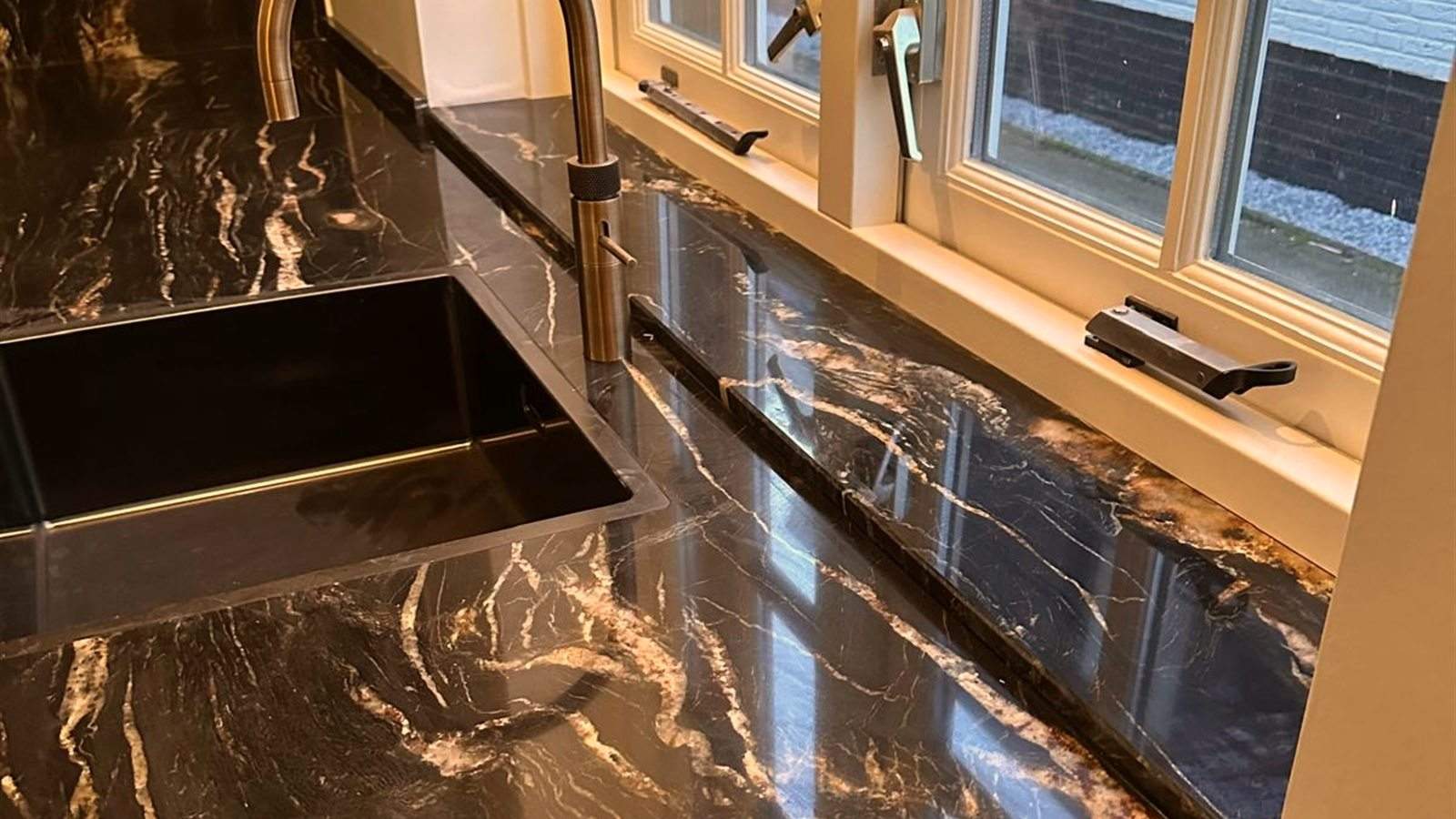 Bruin marmeren werkblad met gouden kraan