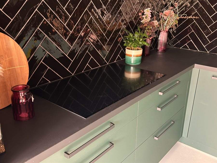Groene keuken met een visgraat tegelwand